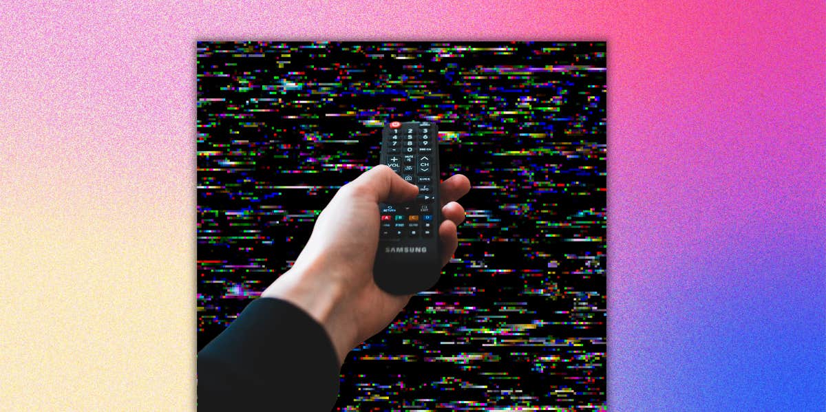 What Your Favorite TV Shows Reveal About You, According To Psychology hand holding tv remote