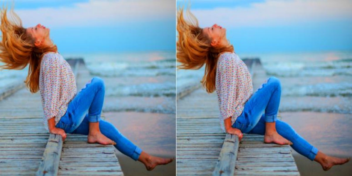 woman sitting on wooden pier throwing her head and hair back