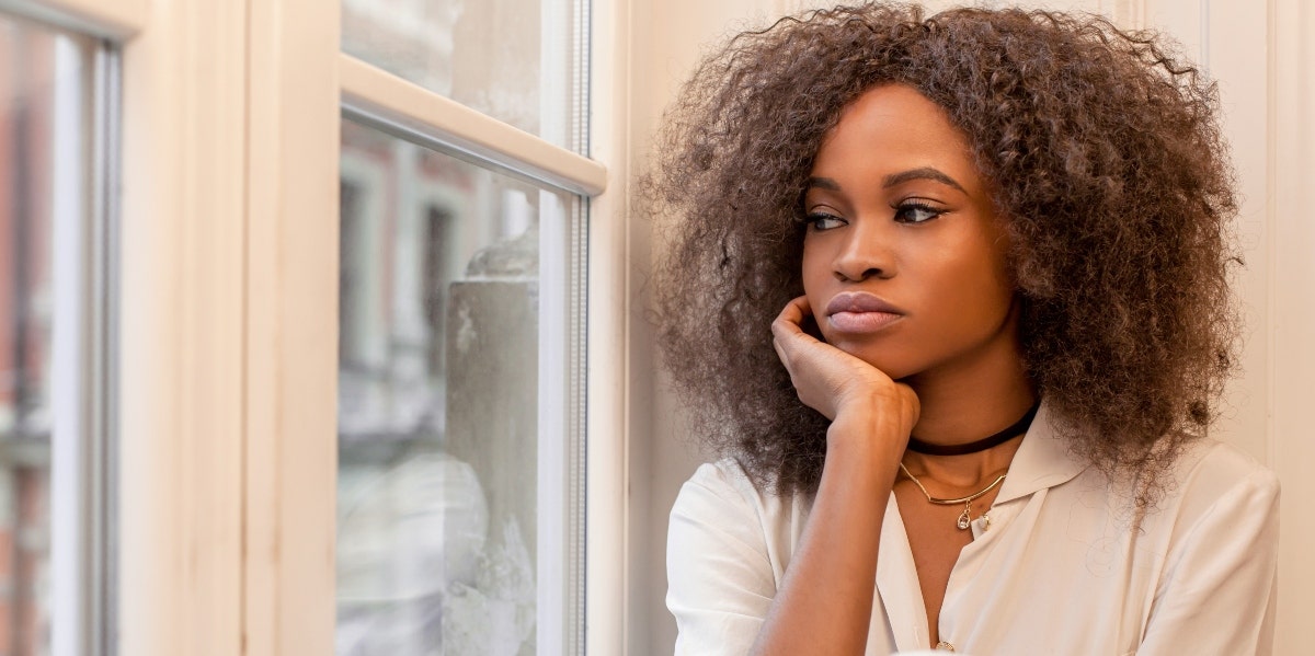 depressed woman looking out the window