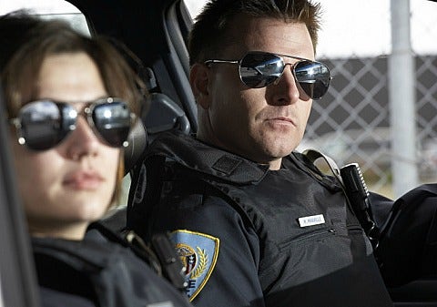 female and male cop in cop car
