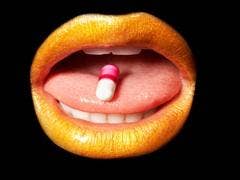 open mouth with pill on tongue