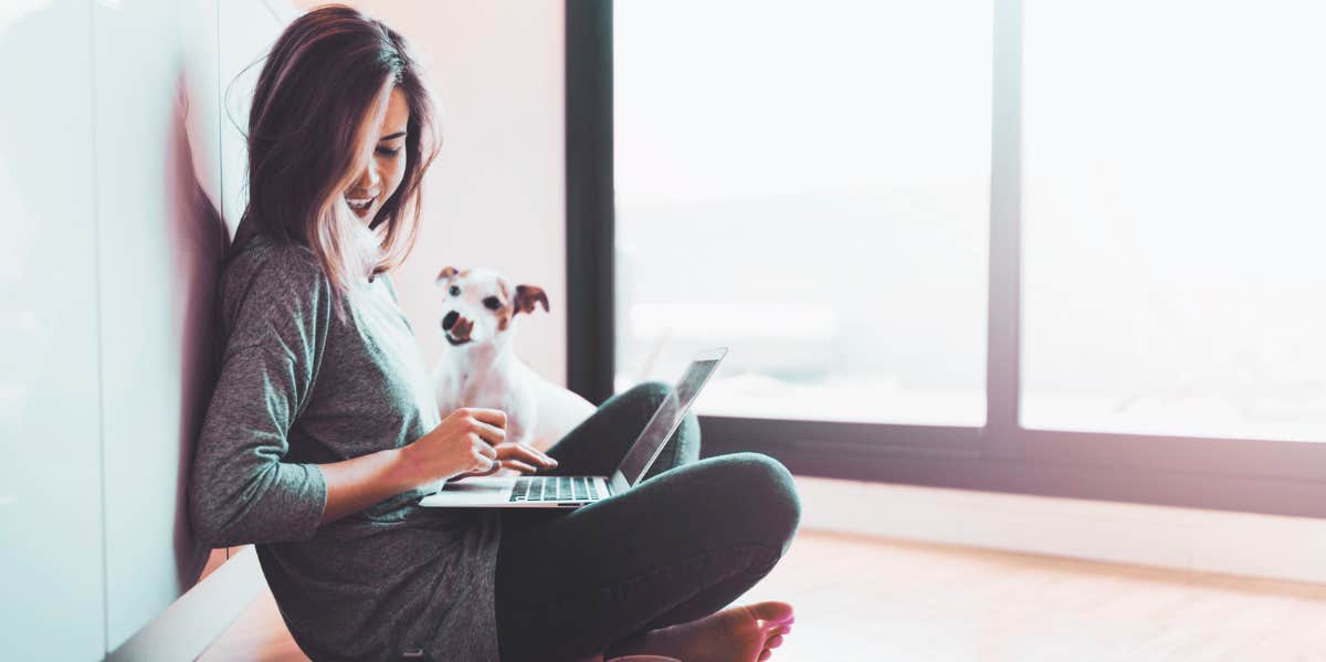 woman sitting on floor with dog