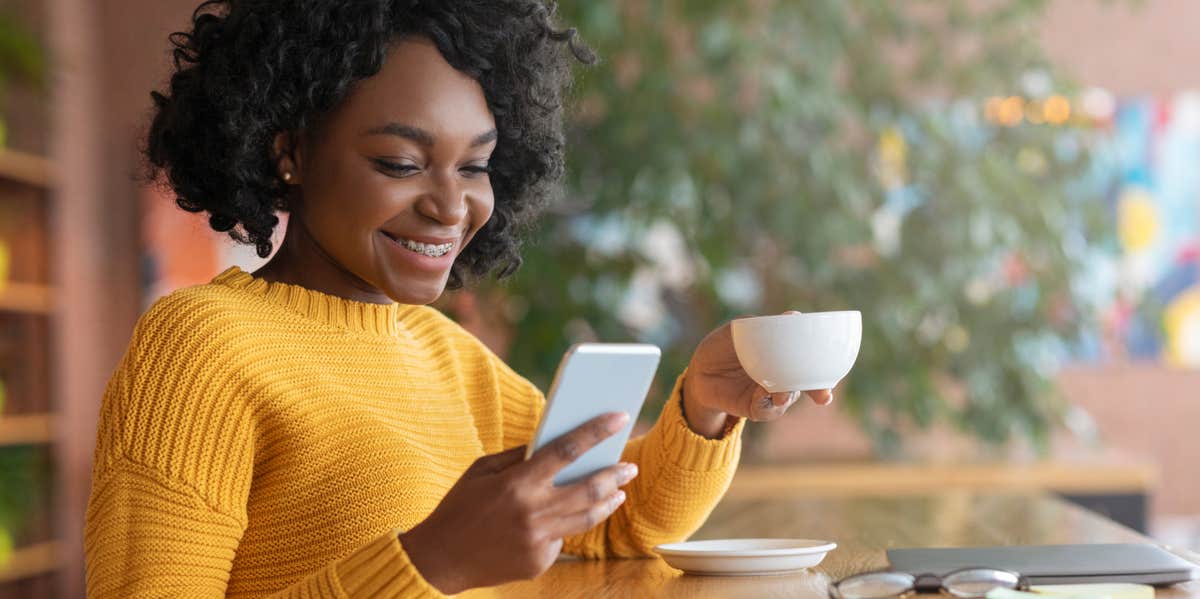 woman scrolling through social media on her phone