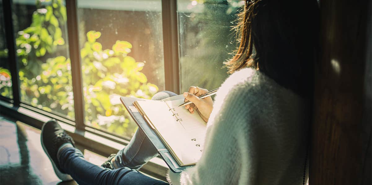 woman writing in journal