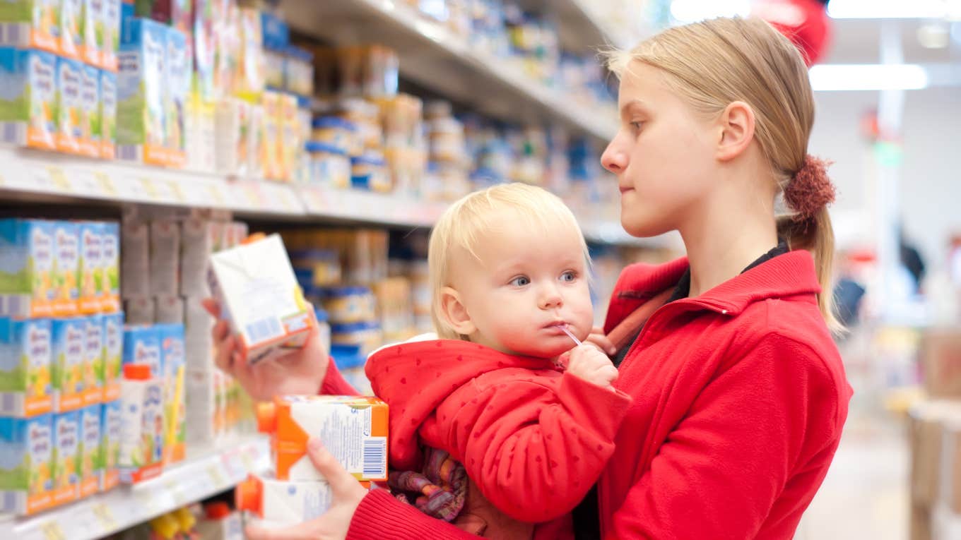 struggling new mom grocery shopping with baby