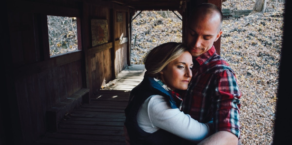 woman hugging man upset sad couple