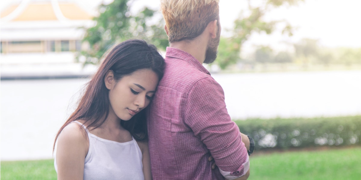 sad woman leaning on man