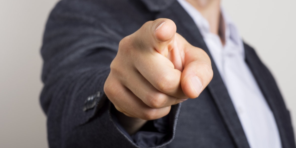 man in suit pointing finger