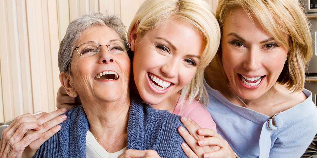 three generations of women posing for photo