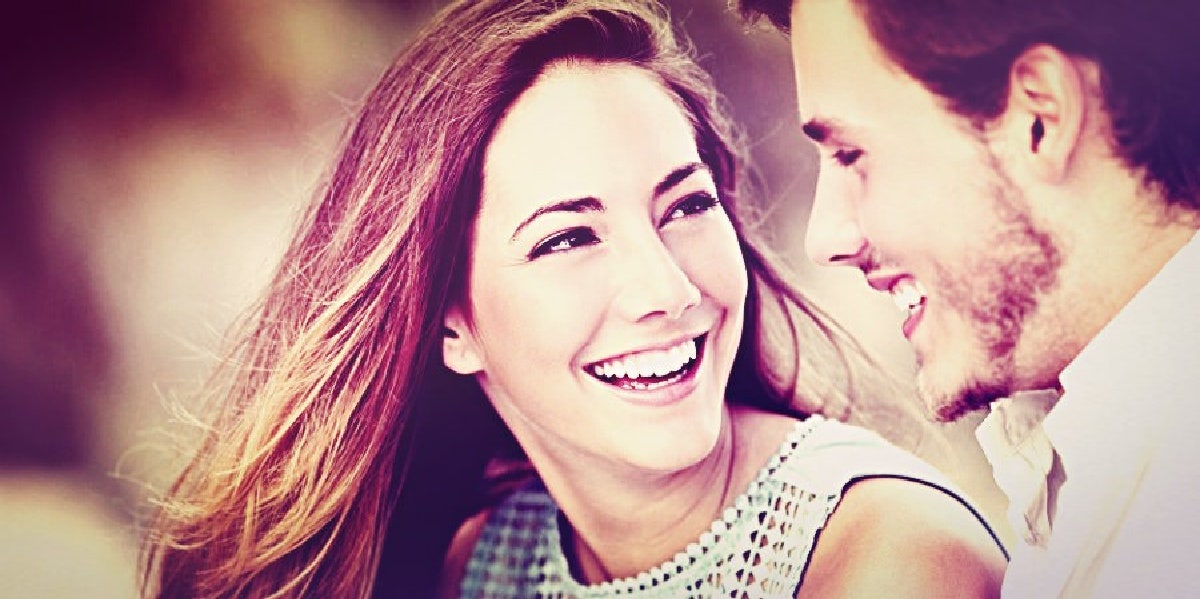 100 First Date Questions: What To Talk About On A First Date couple smiling looking at each other