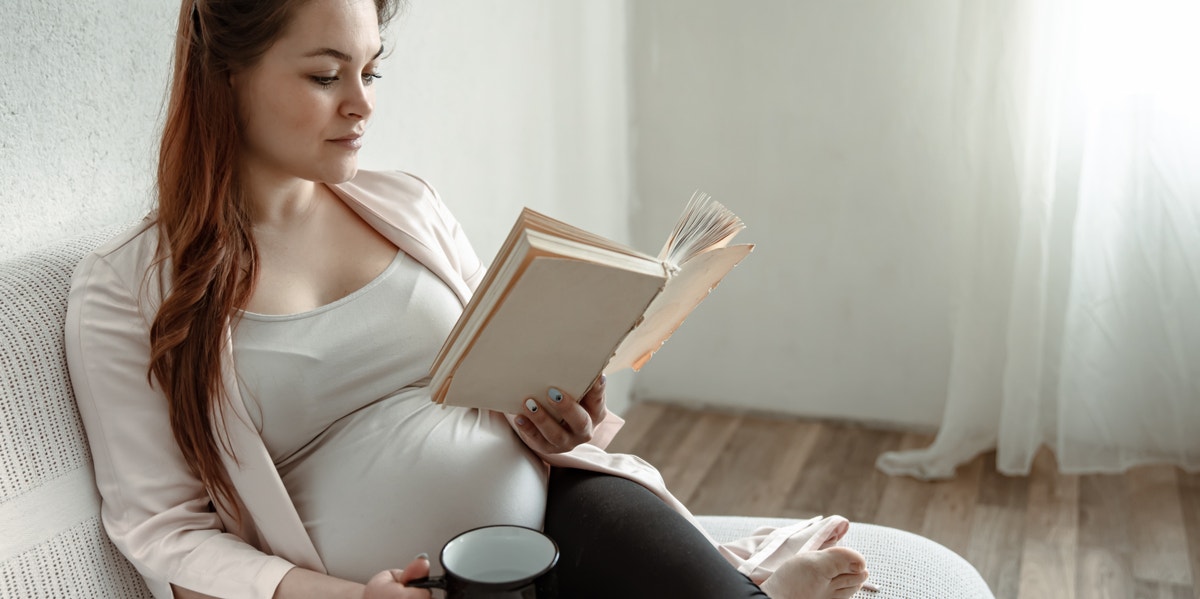 12 First-Time Parenting Books That Will Actually Help You Stay Sane pregnant woman reading