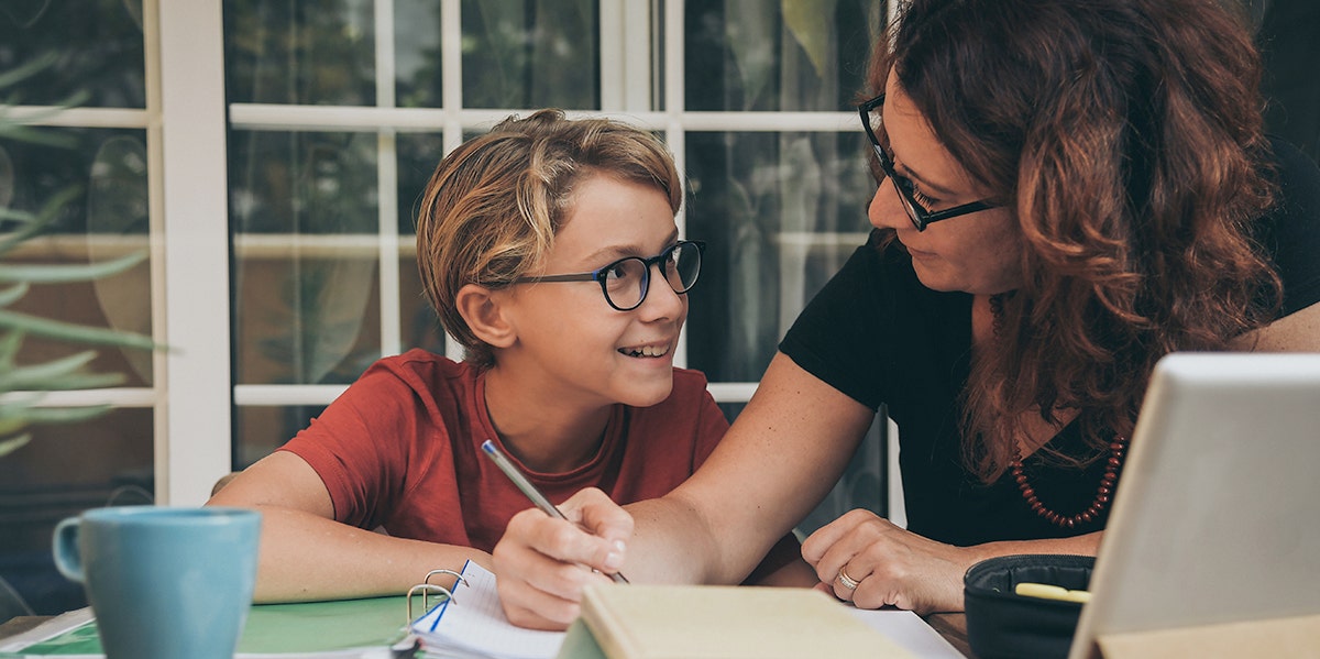 child sitting at table doing homework