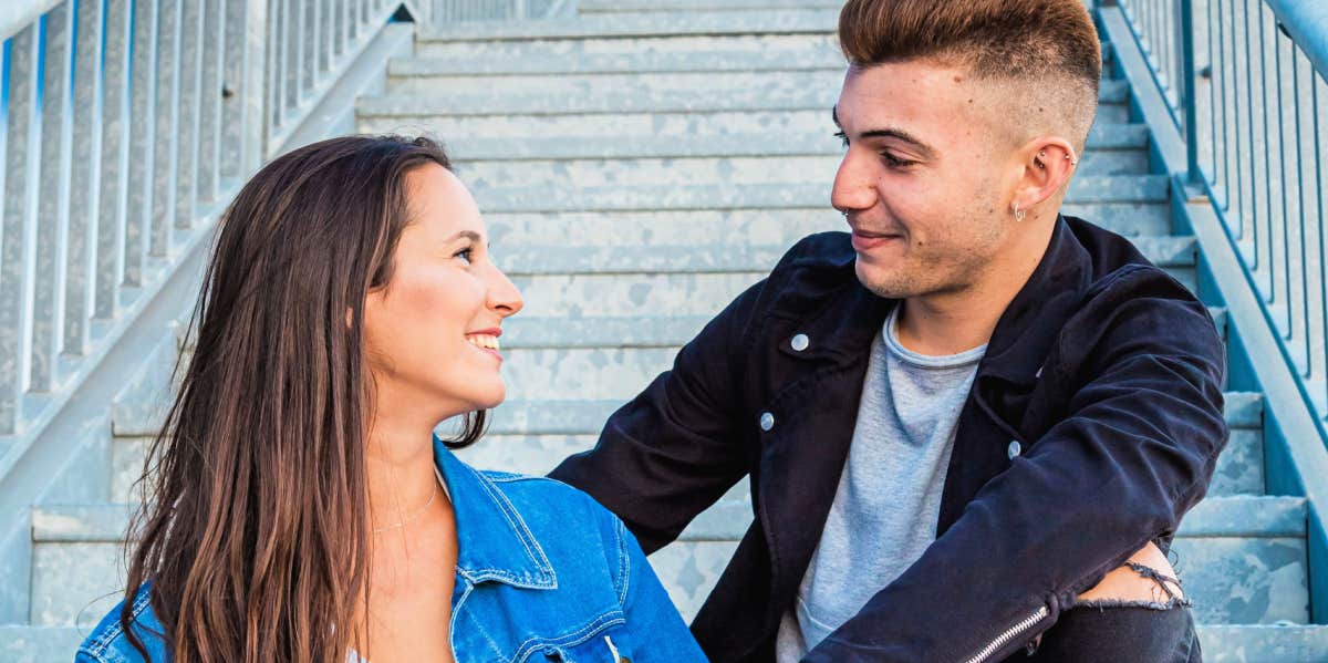 man and woman sitting on stairs talking