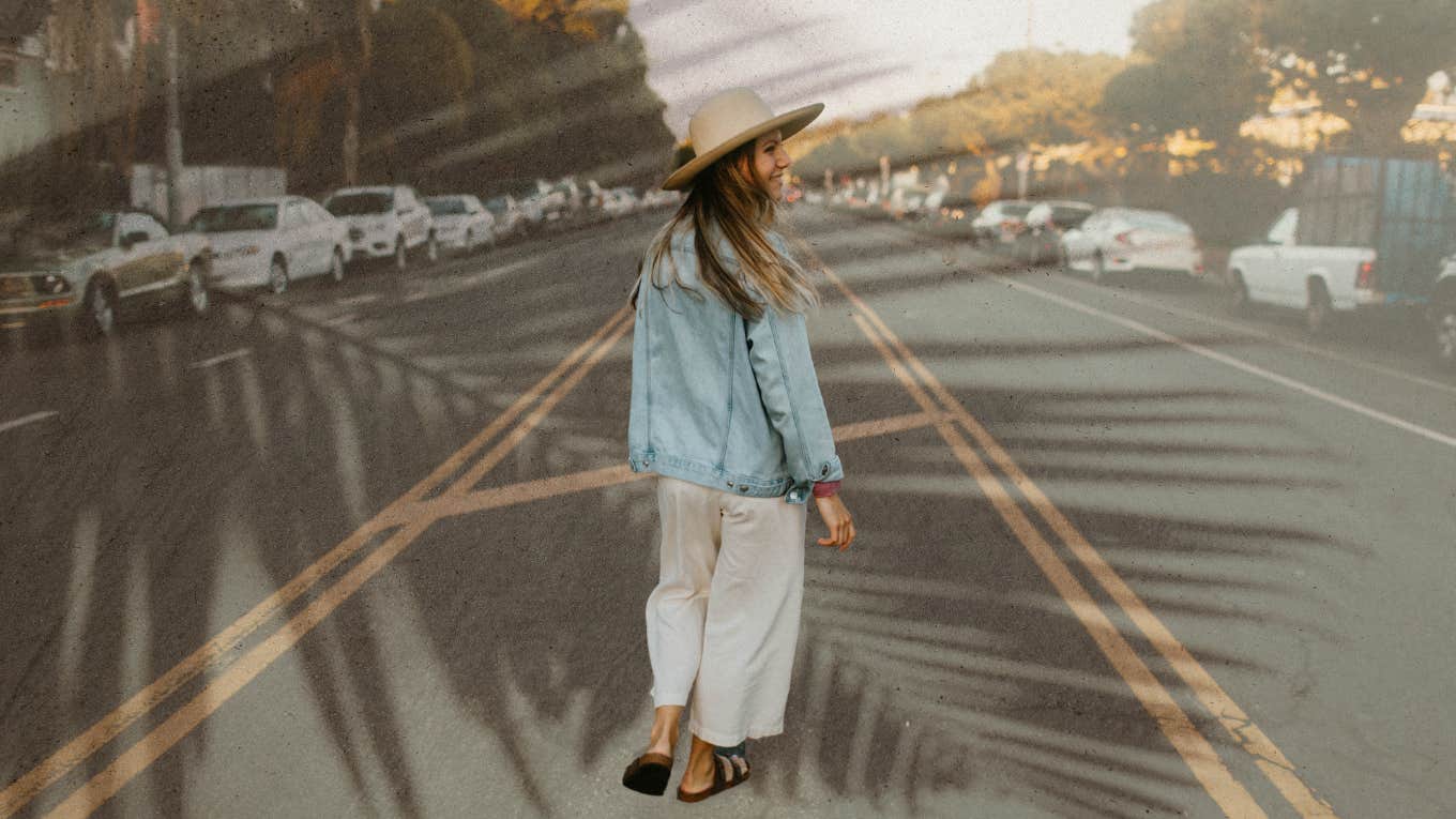 Woman walking down the middle of the road