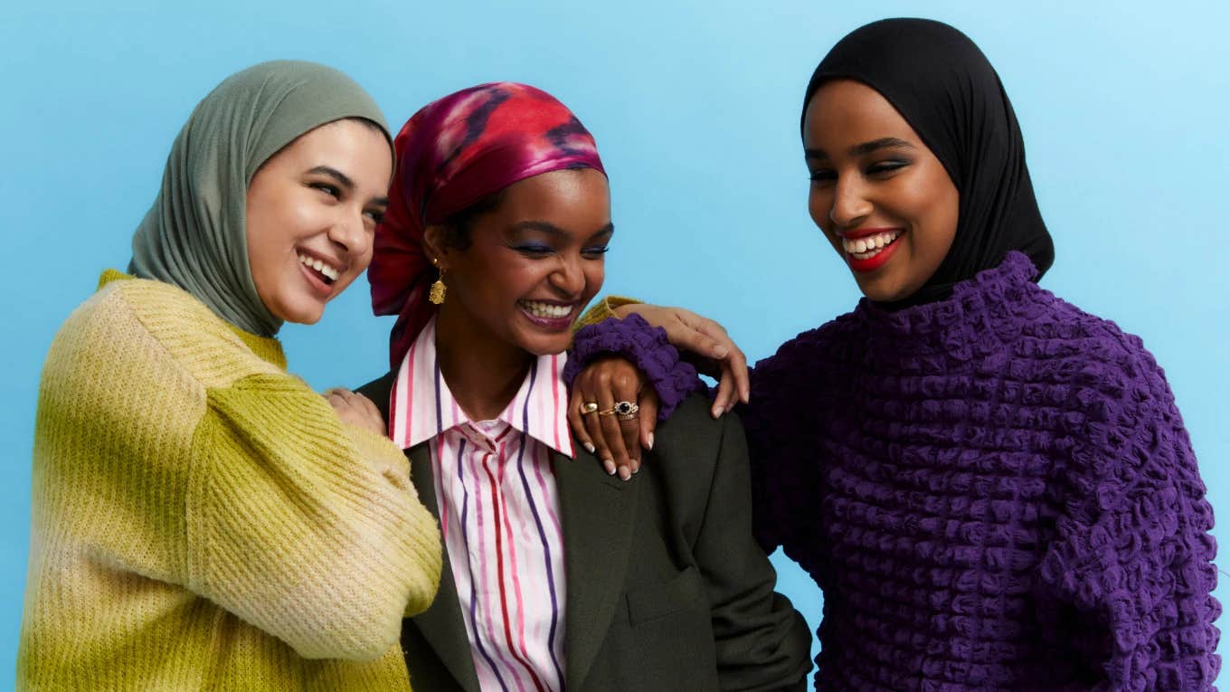 Three woman laughing and hugging each other