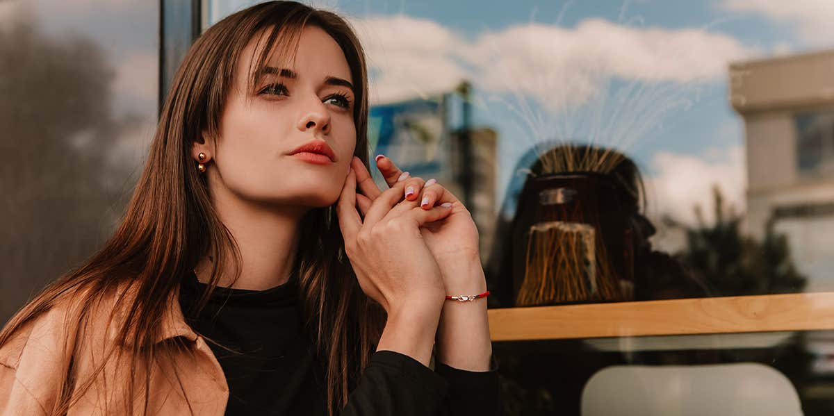 girl sitting outside of cafe