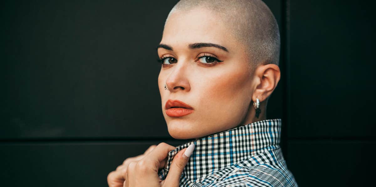 confident woman with shaved head in blazer