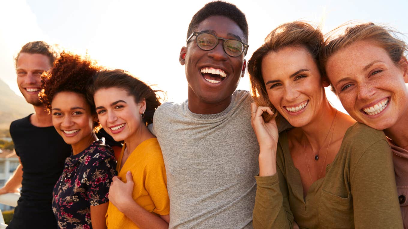 Portrait of smiling young friends walking outdoors together