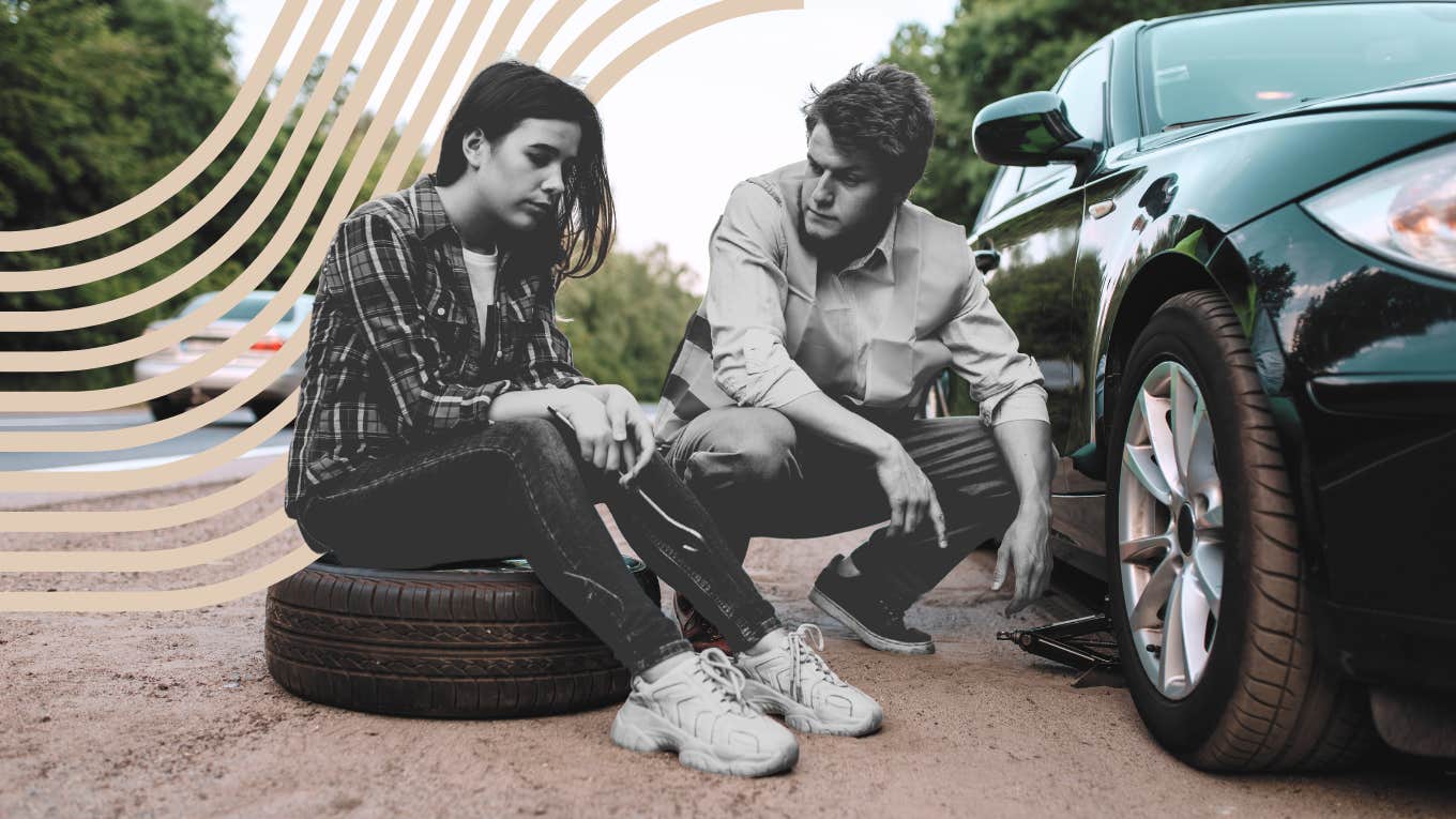 Couple sitting outside of their car changing their tire