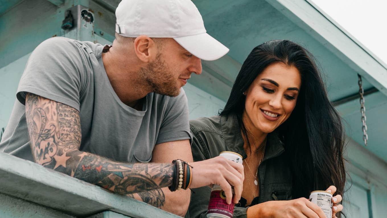 Two people flirting leaning over balcony