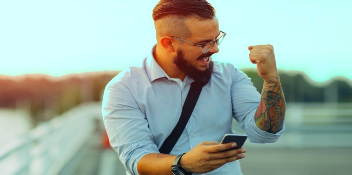 excited man on his phone sending flirty texts