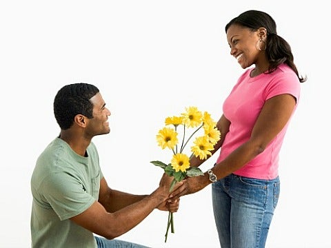 man giving woman flowers