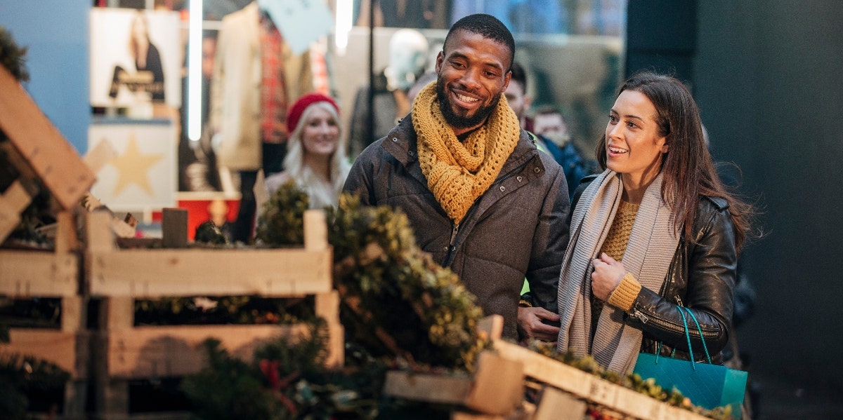 man and woman christmas tree shopping