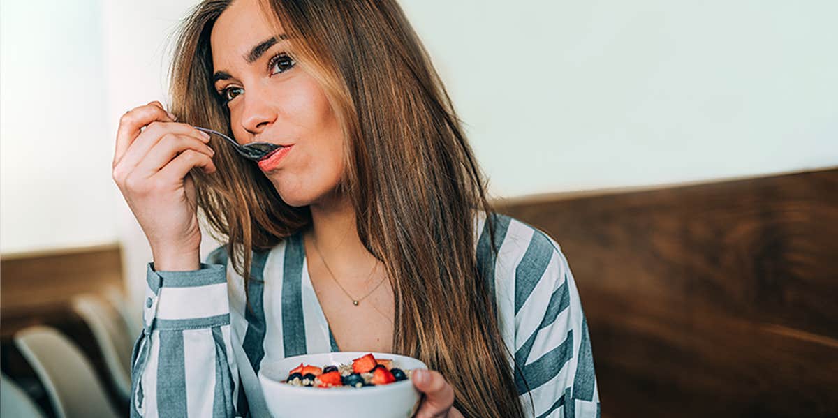 18 Foods That Help With Anxiety And Stress woman eating breakfast