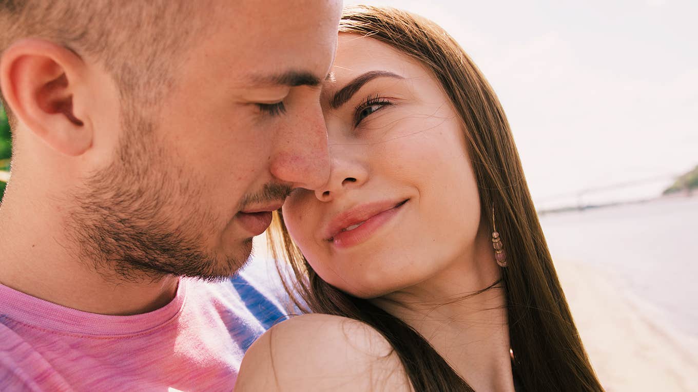 woman looking longingly at her forever person on the beach