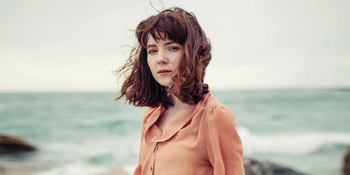 forgiving an ex after divorce Sad woman by seaside