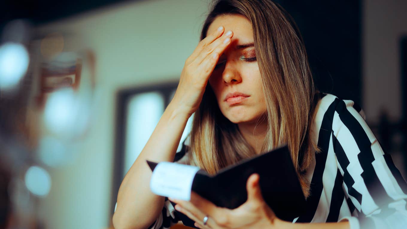 unhappy woman seeing restaurant bill