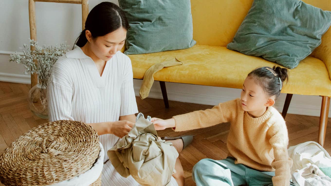 woman and child folding laundry 