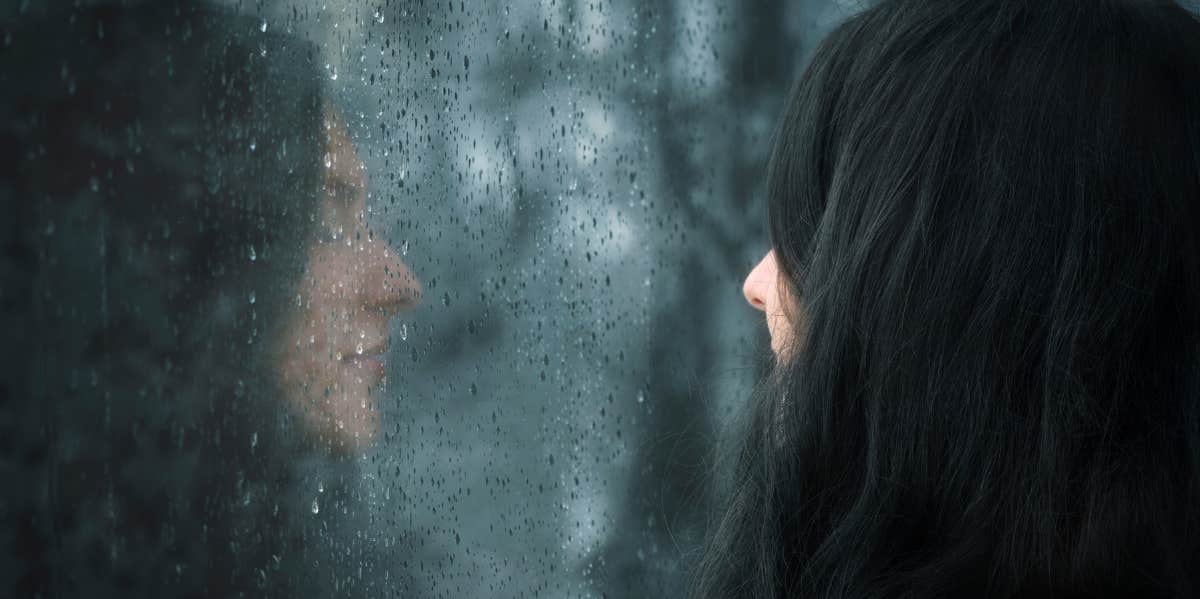 woman looking out a window