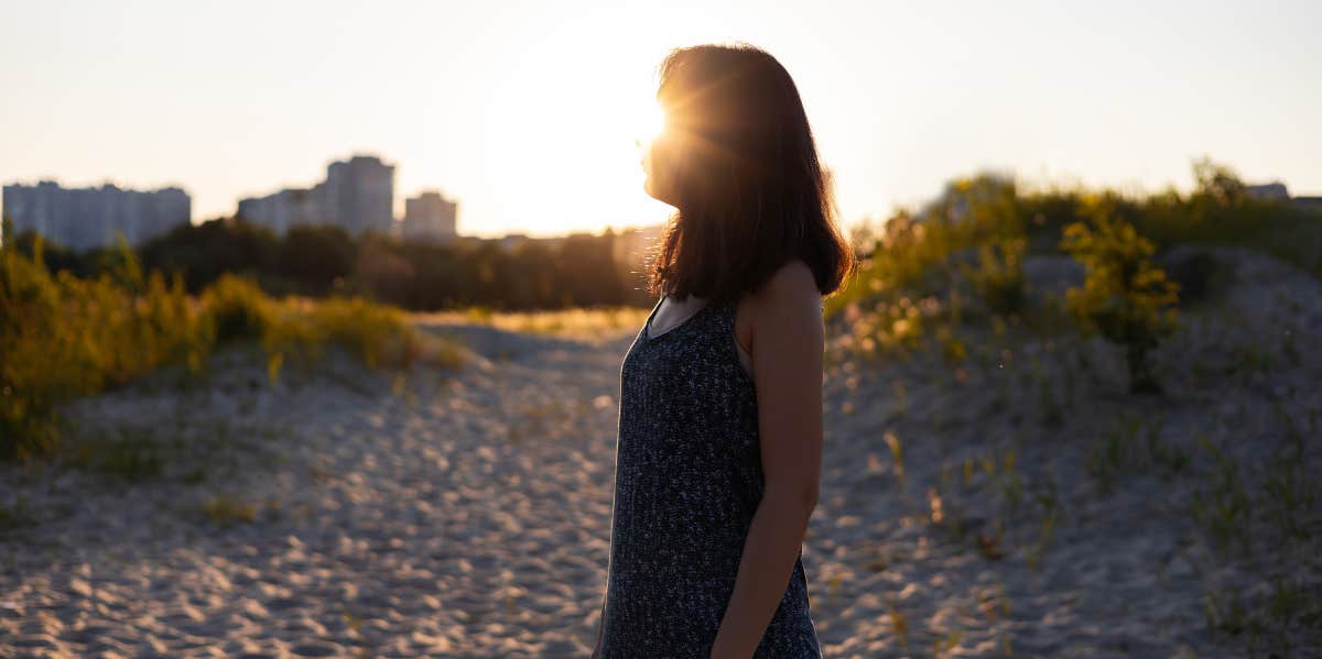 woman looking into sunset