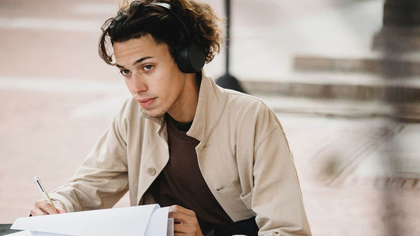 college student studying while wearing headphones