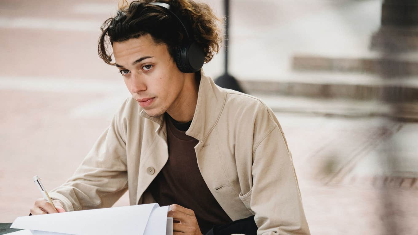 Frustrated Mom Explains Why Her Son Wants To Quit College After Only 4 Days college student studying while wearing headphones