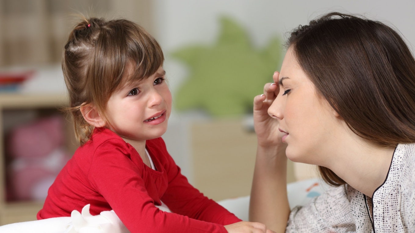 Frustrated mom listening to crying toddler.