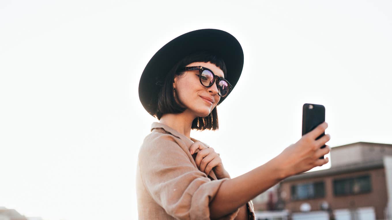 woman taking selfie on her phone