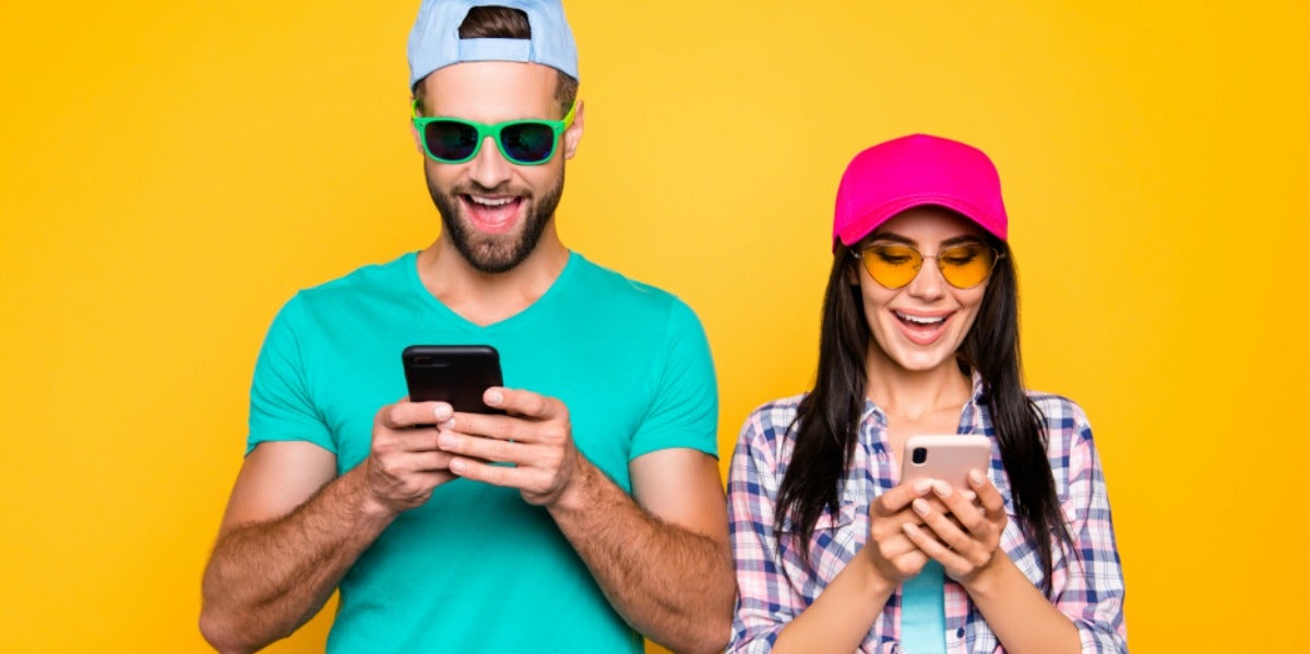 man and woman looking at smartphones