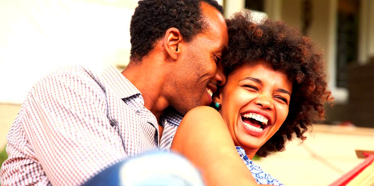 married couple hugging and laughing at funny marriage advice