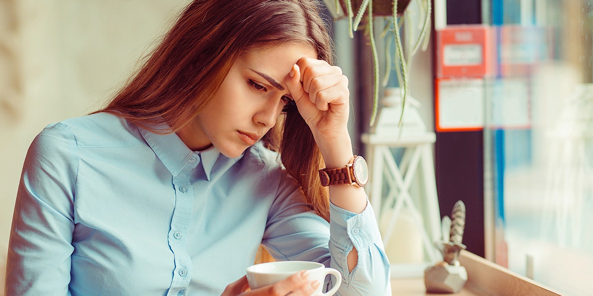 sad woman holding coffee