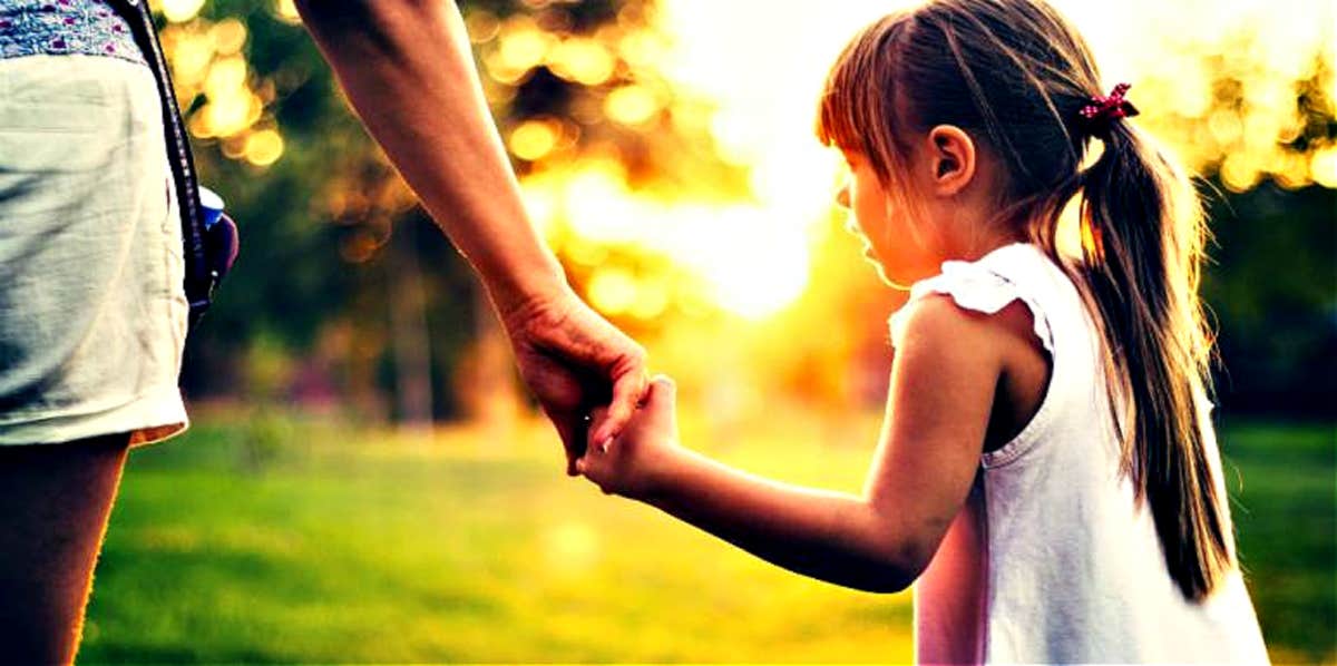 little girl holding mom's hand