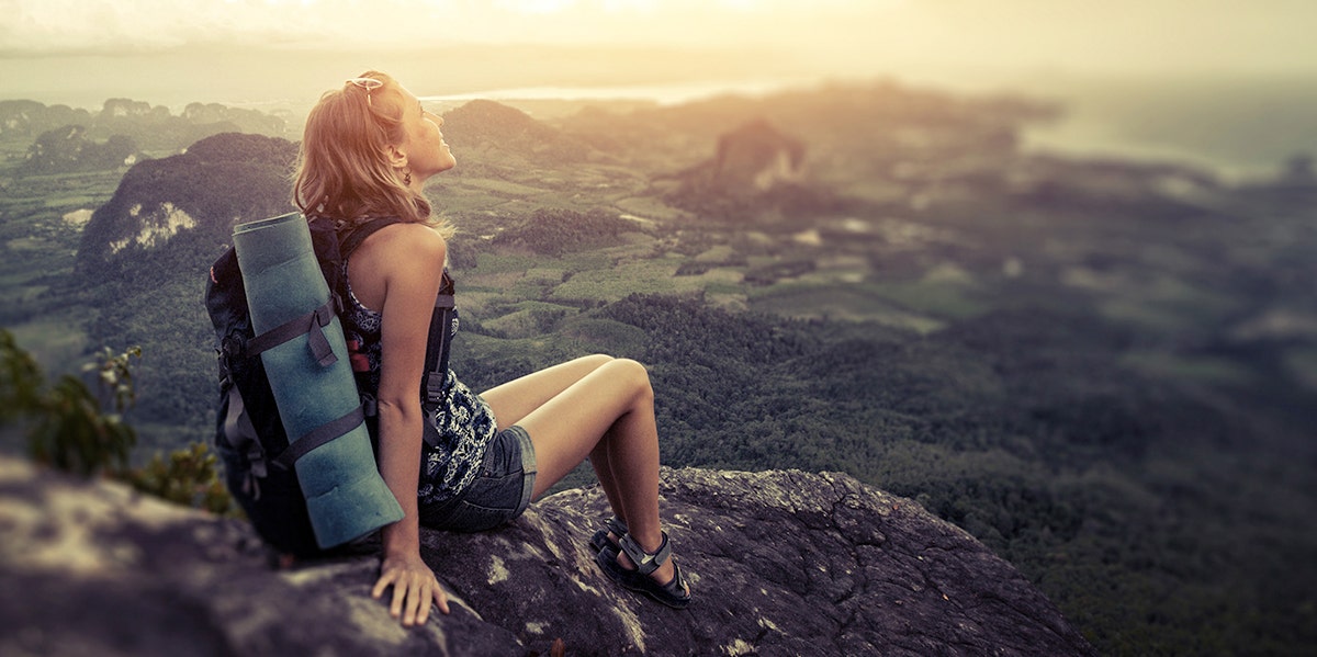 What I Learned About Myself When I Purged Almost Everything I Owned woman wearing backpack looking out at world
