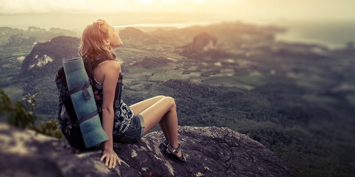 woman wearing backpack looking out at world