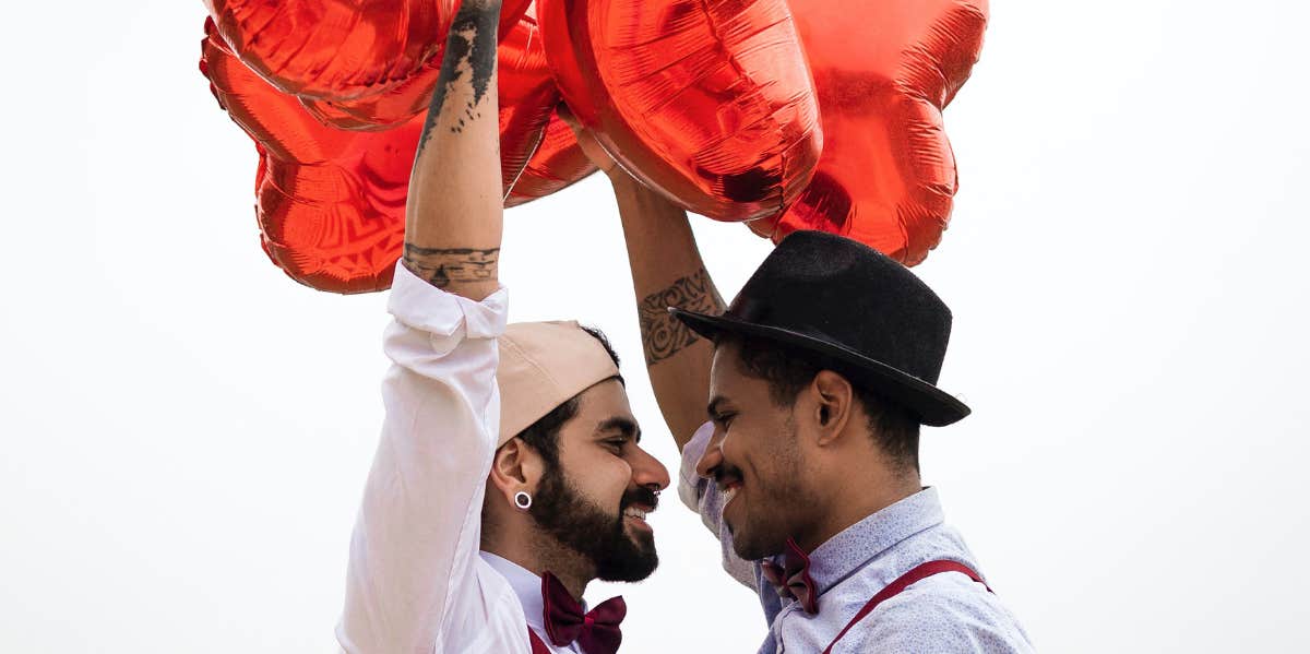 men holding balloons