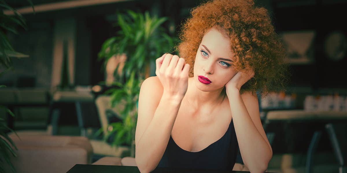 This Type Of Nail Polish May Cause Cancer, According To Research concerned woman looking at her nails