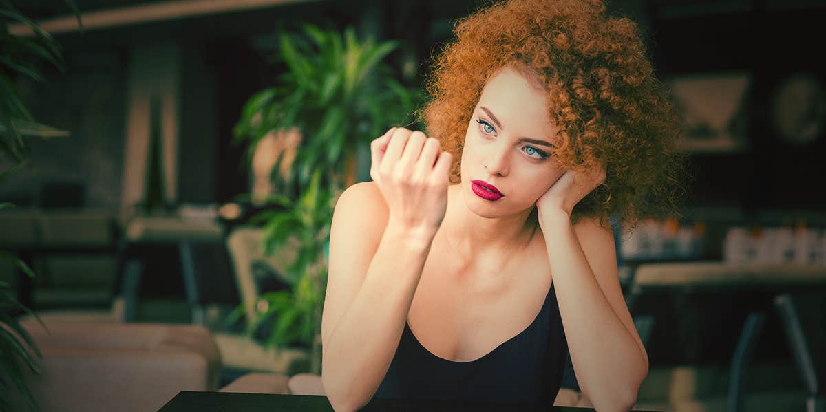 concerned woman looking at her nails