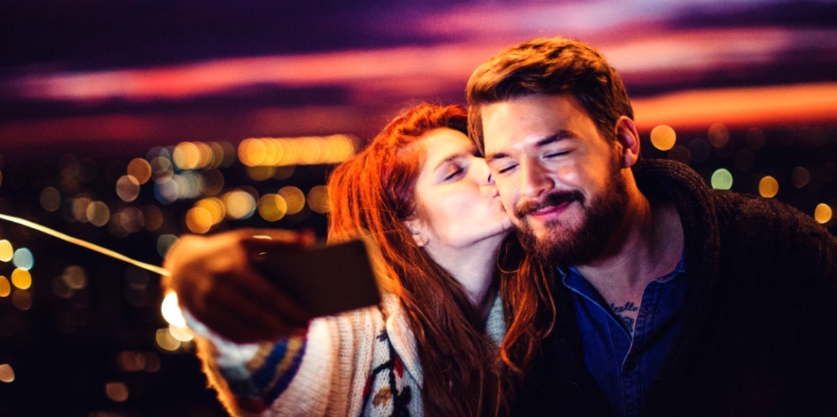 man and woman posing for selfie