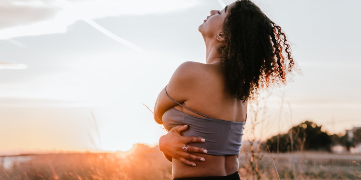 woman liberated hugging self