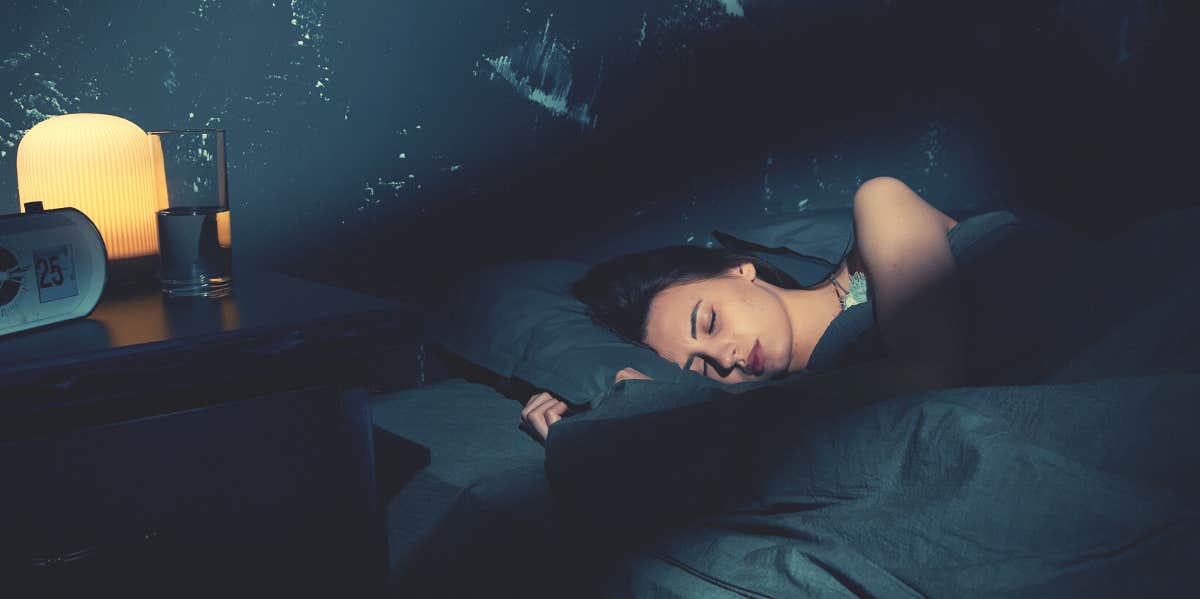 The Only Thing You Need To Keep By Your Bed To Absorb Negative Energy woman sleeping peacefully